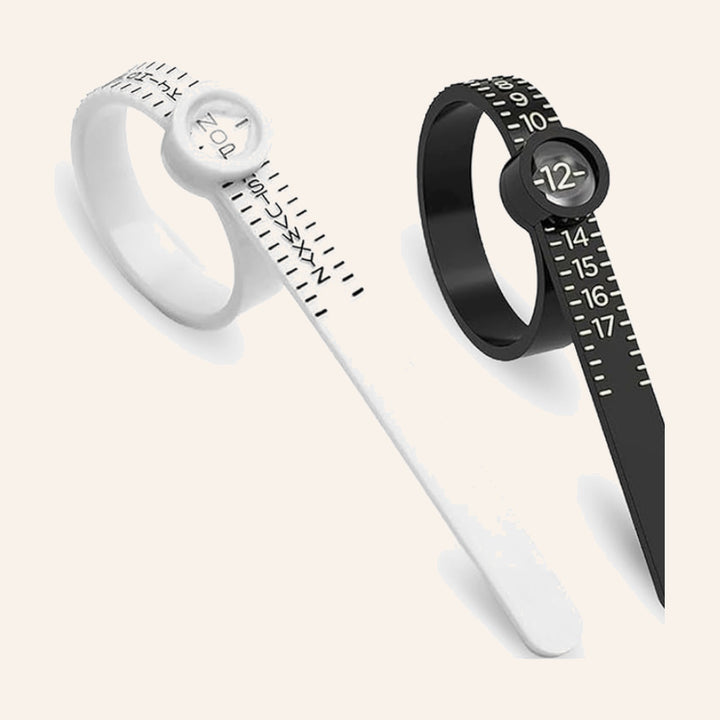 Adjustable ring sizer marked in UK letter sizes, shown in white and black, from THE LAB Jewellers